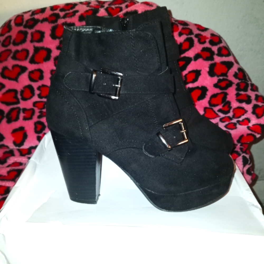 Leather high heel booties..with double buckles and an inside zippers.